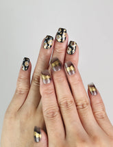 Model wearing Mystic Flow handmade press on nails with abstract swirls and metallic leaf details, bold Singapore press on nails look